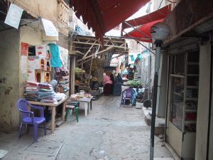 Des femmes devant une épicerie dans une ruelle